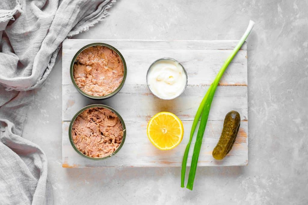 Keto Tuna Salad Overhead shot of the ingredients laid out on a rustic white washed board.