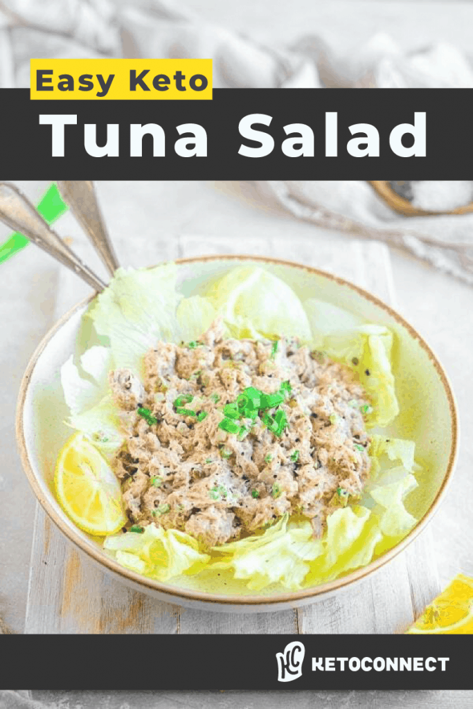 Angled shot of tuna salad in a bowl with romaine lettuce leaves under it.