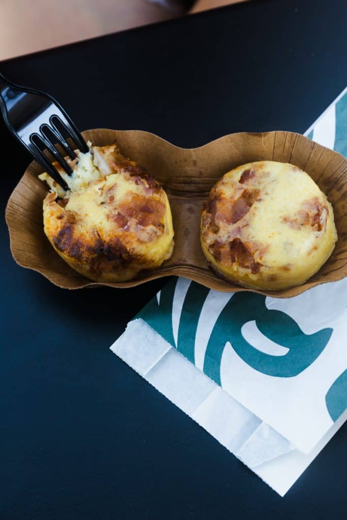 keto starbucks sous vide egg bites in container with starbucks bag underneath