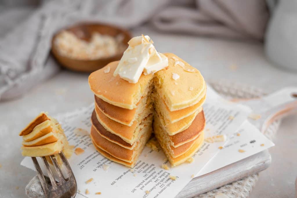 Protein pancakes with a perfect cut. Stack held by a silver fork