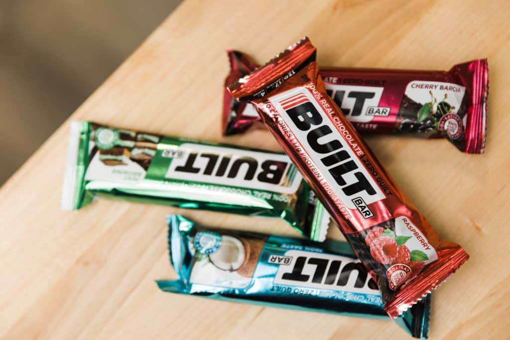 pile of different flavor built bars on a wood table