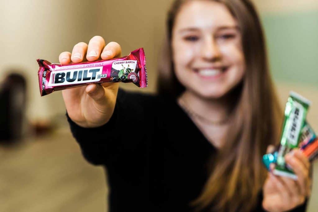 woman holding a built bar in one hand