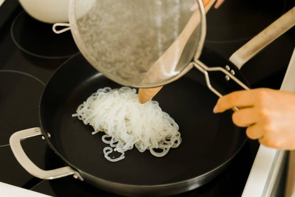 Sautéing the miracle noodles in a cast iron pan