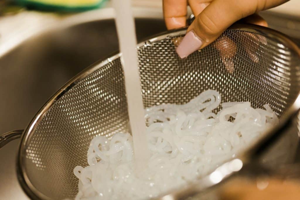 Miracle Noodle Reviews Rinsing miracle noodles in a strainer under running water