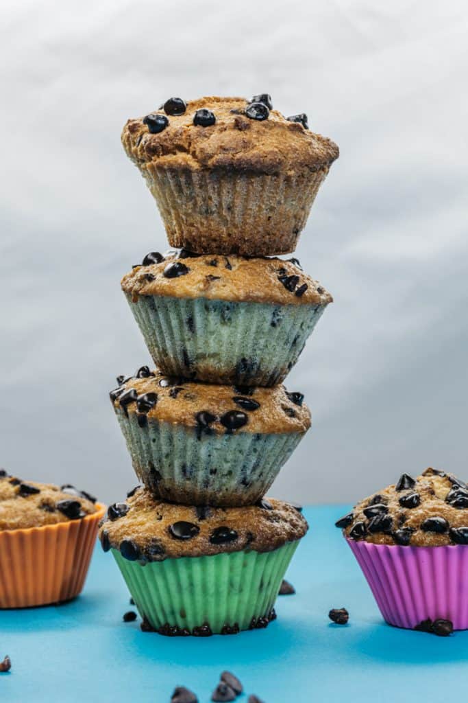 keto chocolate chip muffins A tower of almond flour muffins in bright silicone muffin liners