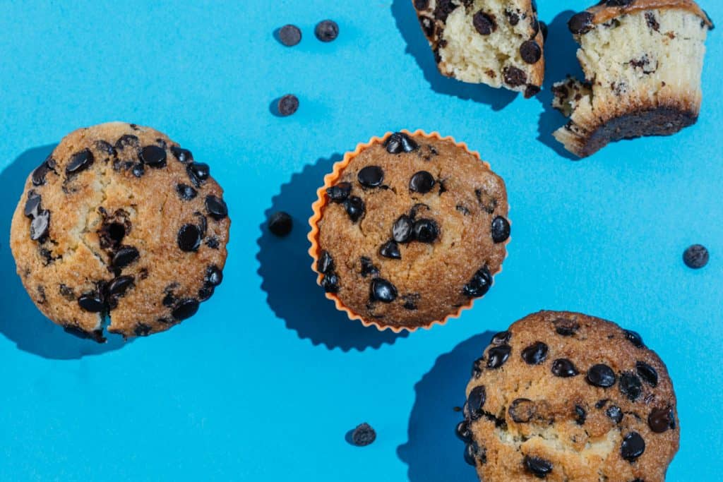 keto chocolate chip muffins Bright blue backdropped chocolate chip muffin pop art.