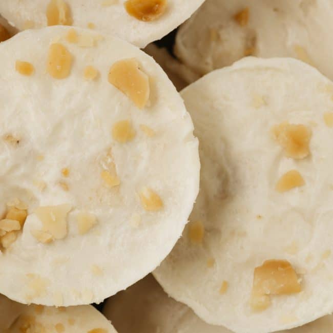 very close shot of a stack of fat bombs with macadamia nuts