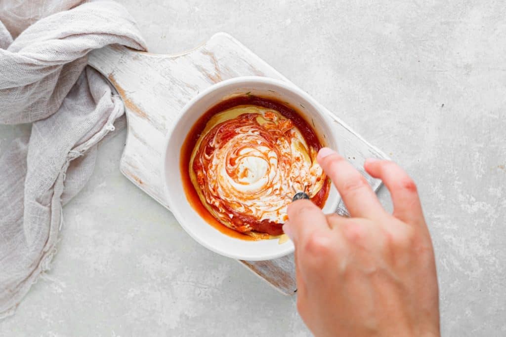 Big mac salad dressing being mixed together in a small white bowl