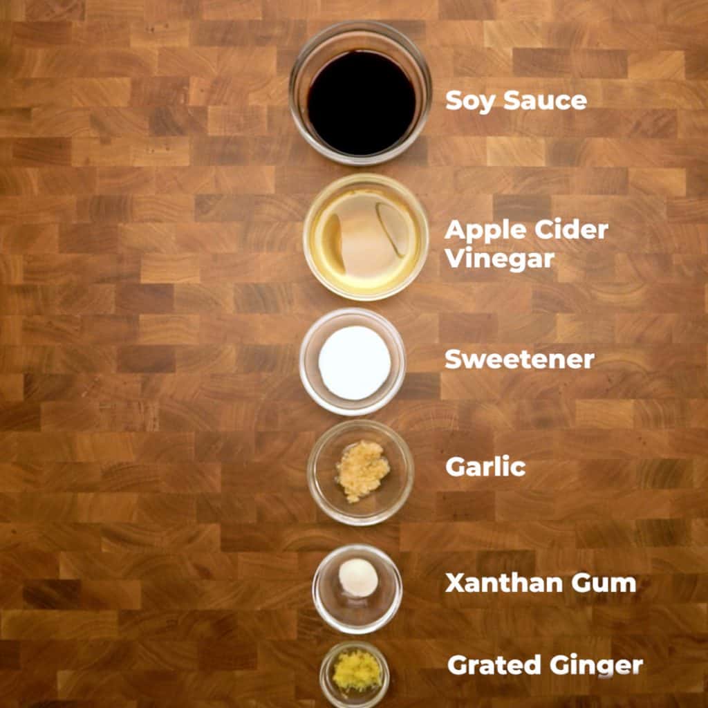 keto teriyaki sauce Overhead shot of ingredients for keto teriyaki sauce in bowls on a table. they are all labeled