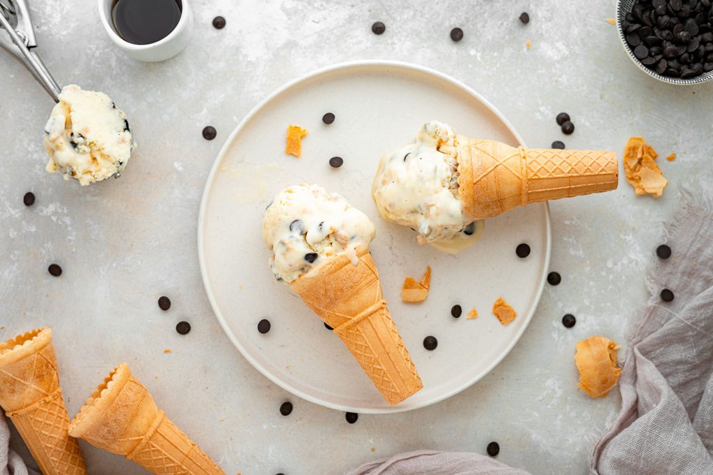 almond milk ice cream two ice cream cones on a plate with chocolate chips