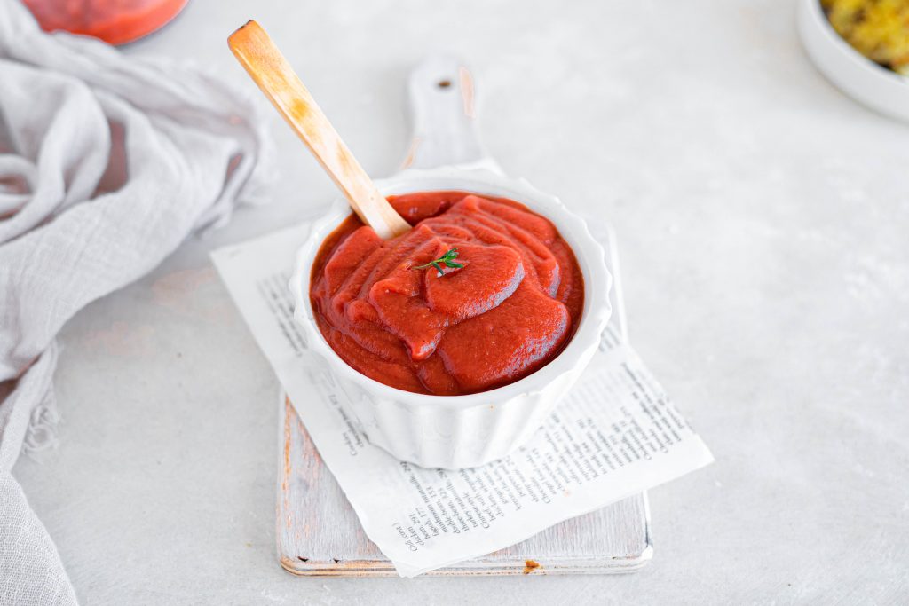 keto ketchup recipe keto ketchup in a bowl with a spoon