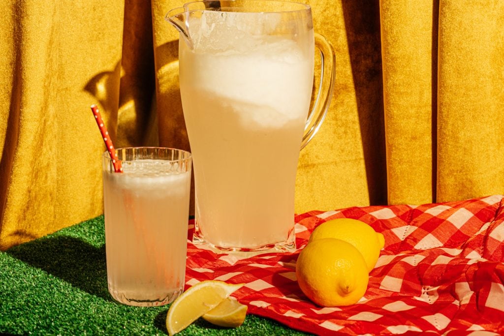 pitcher of sugar free lemonade and a glass on a table