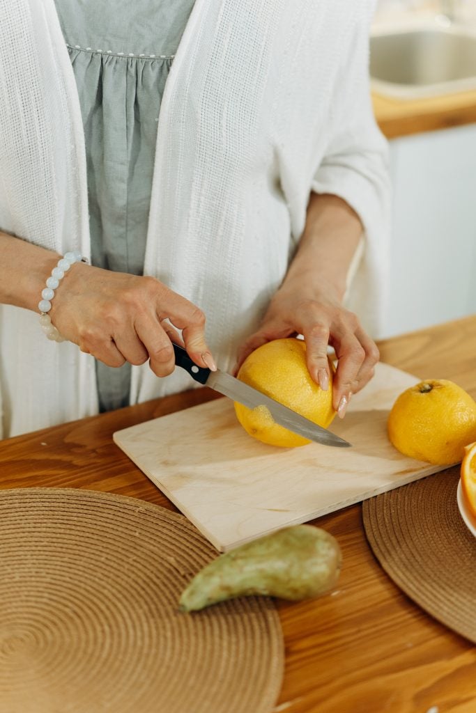 older woman cutting lemons