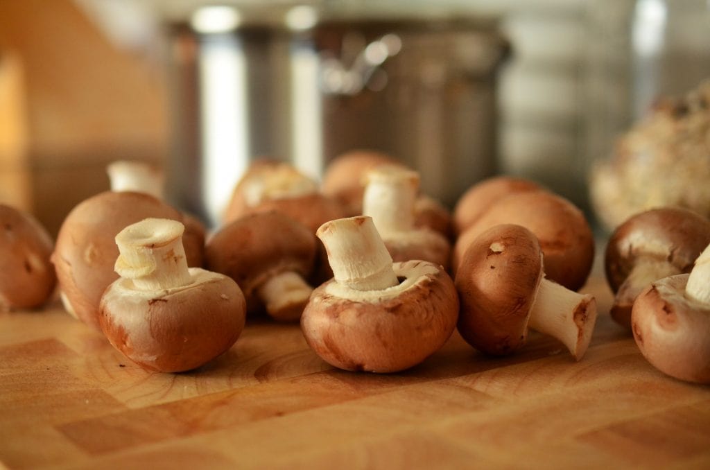 brown mushrooms on a table for cooking