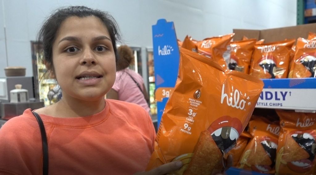 woman holding hilo life keto chips at costco