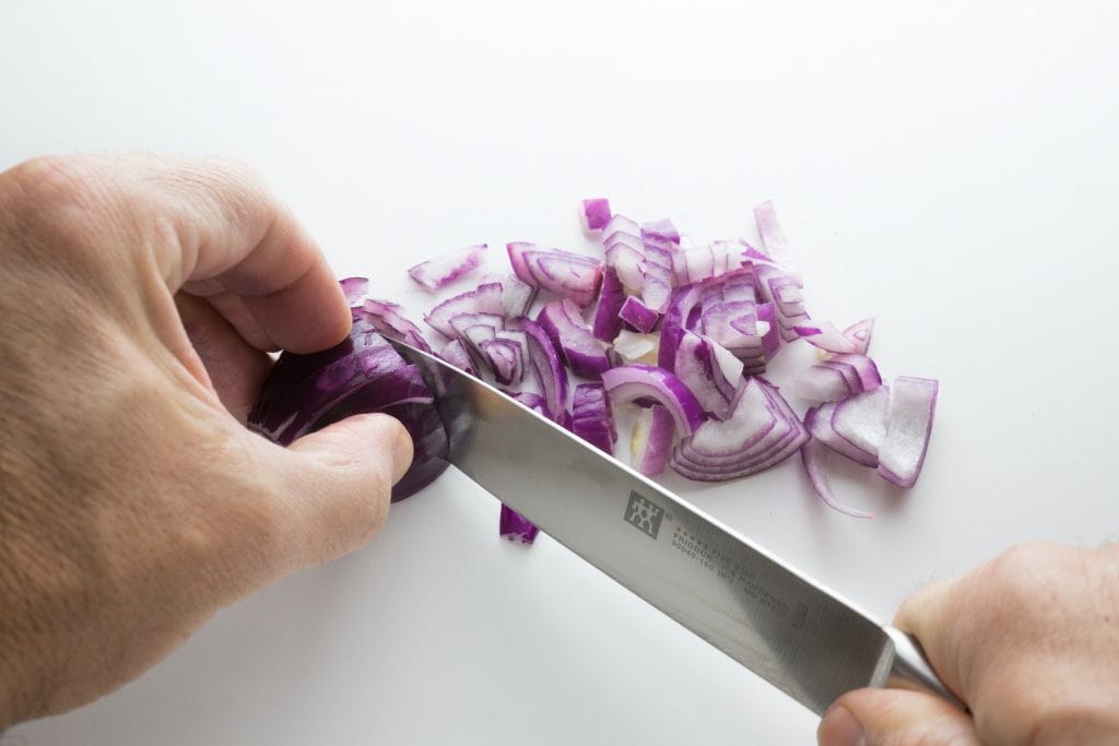 chopping a shallot for cooking