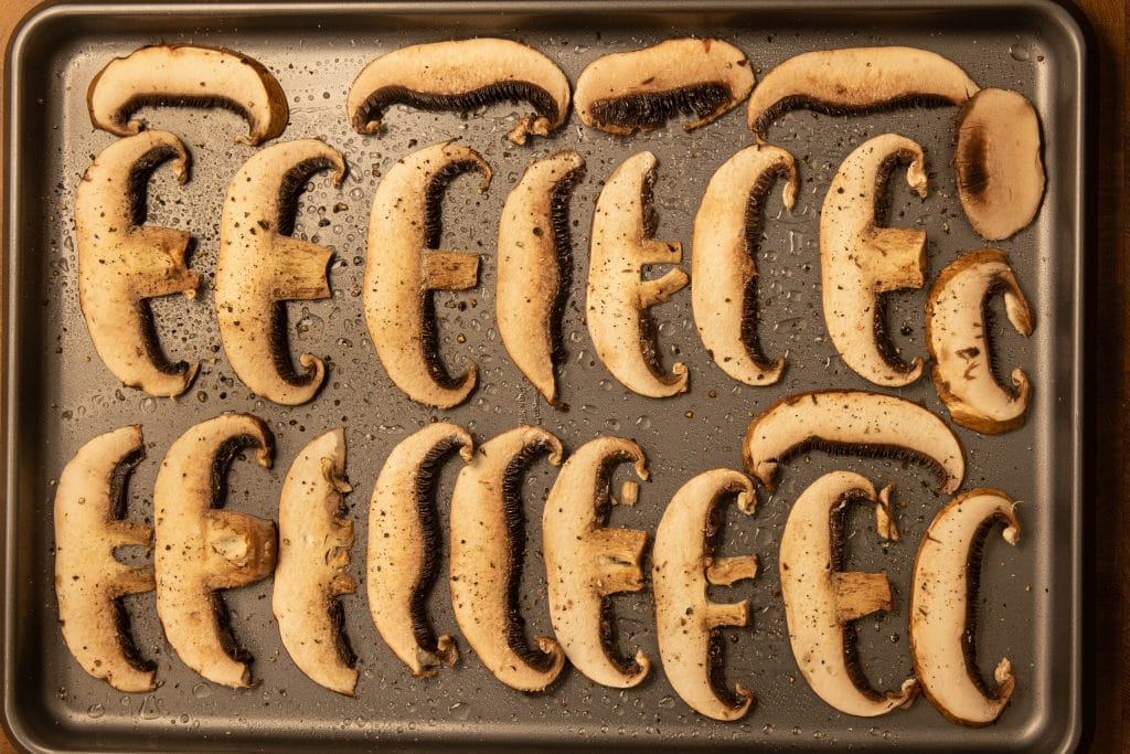 mushroom chips mushrooms laid out on a baking sheet