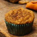 a single pumpkin muffin on a cutting board