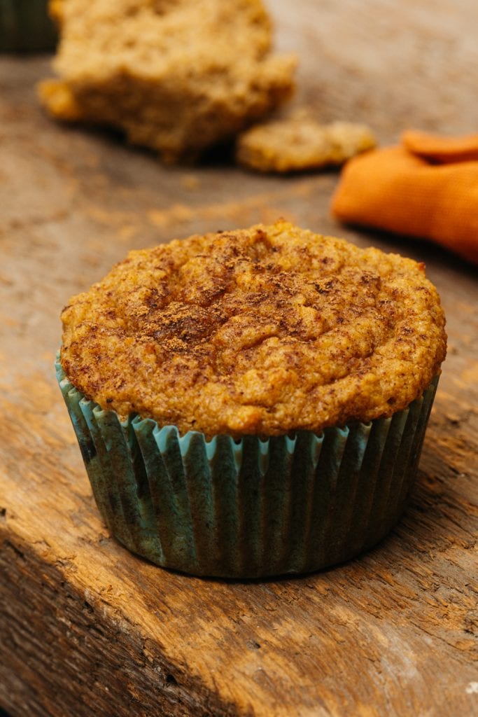 keto pumpkin muffins a single pumpkin muffin on a cutting board