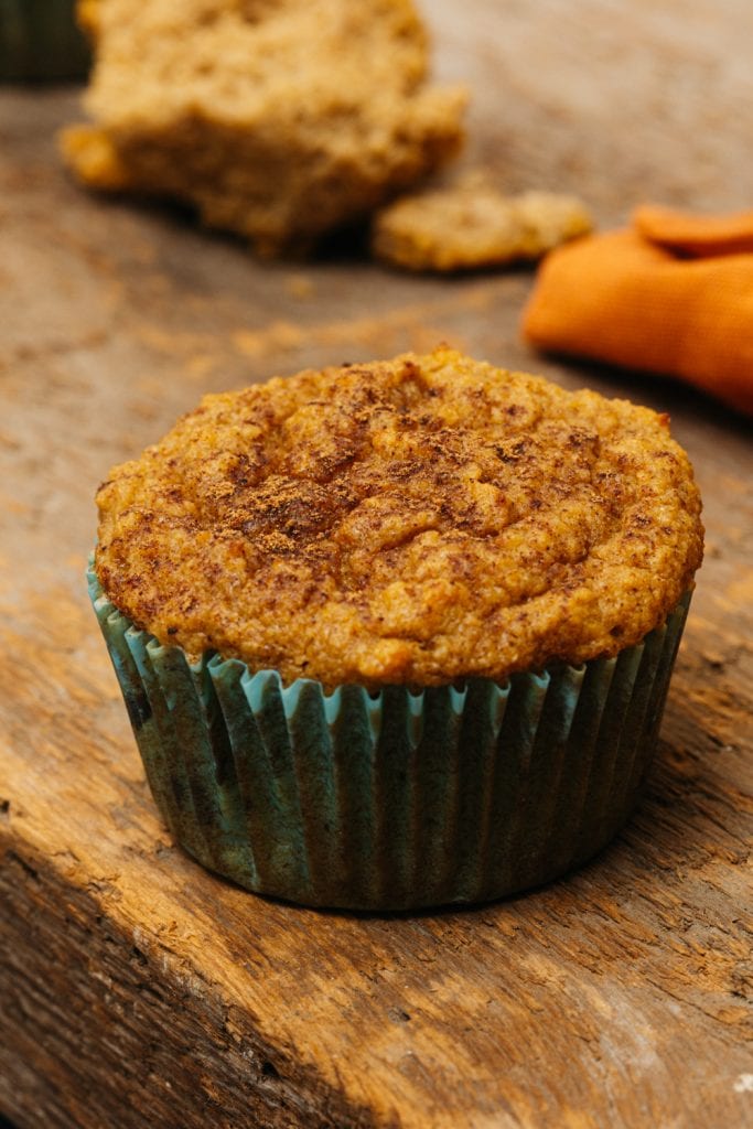 a single pumpkin muffin on a cutting board