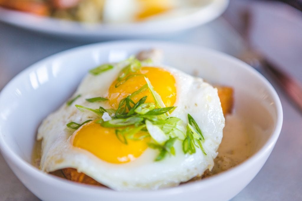 two sunny side up eggs over potatoes