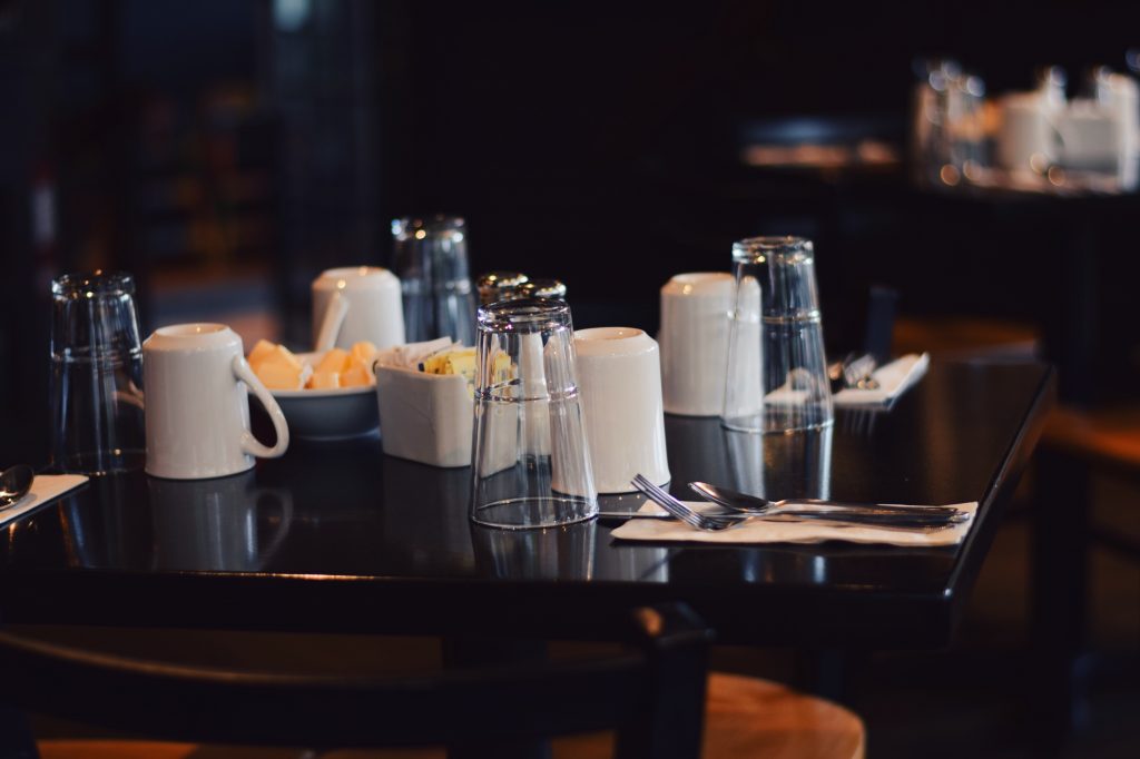 A table set with glasses and silverware for breakfast