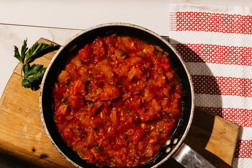 keto spaghetti sauce in a skillet on a cutting board