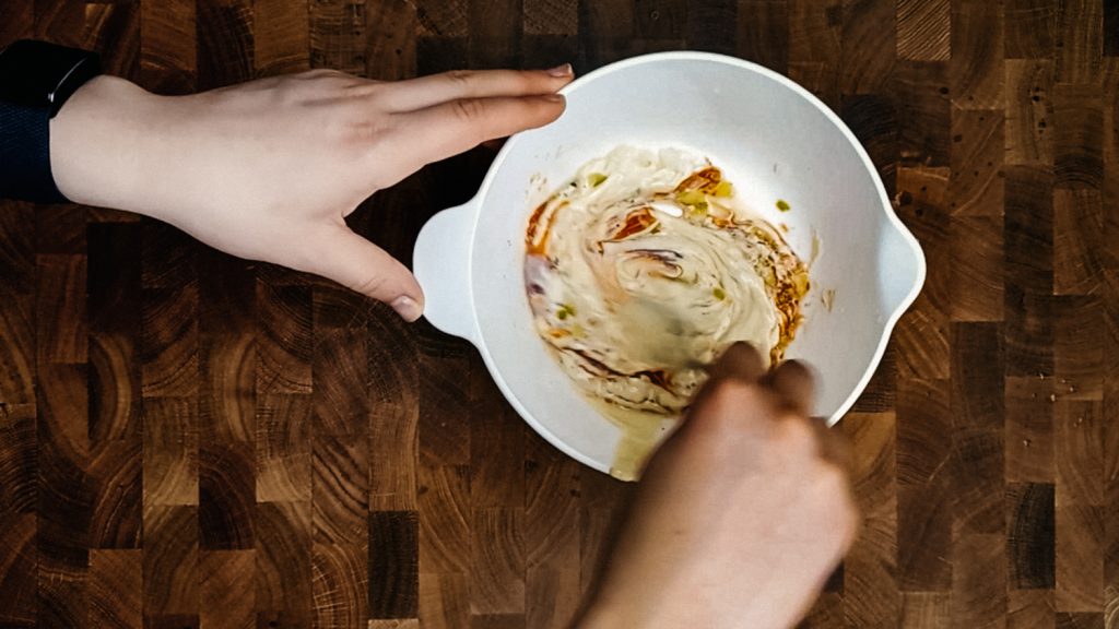 Stirring a bowl of homemade thousand island dressing