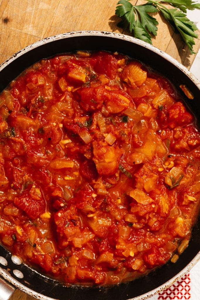 are tomatoes keto keto spaghetti sauce in a skillet on a cutting board