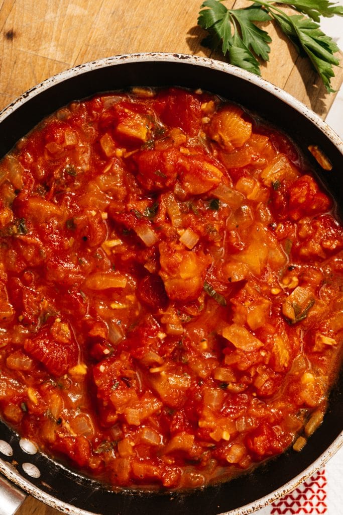 keto spaghetti sauce in a skillet on a cutting board