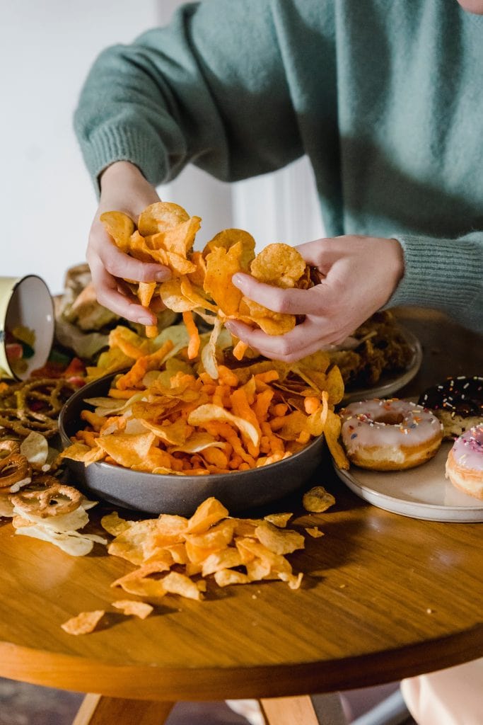 large pile of chips and pretzels