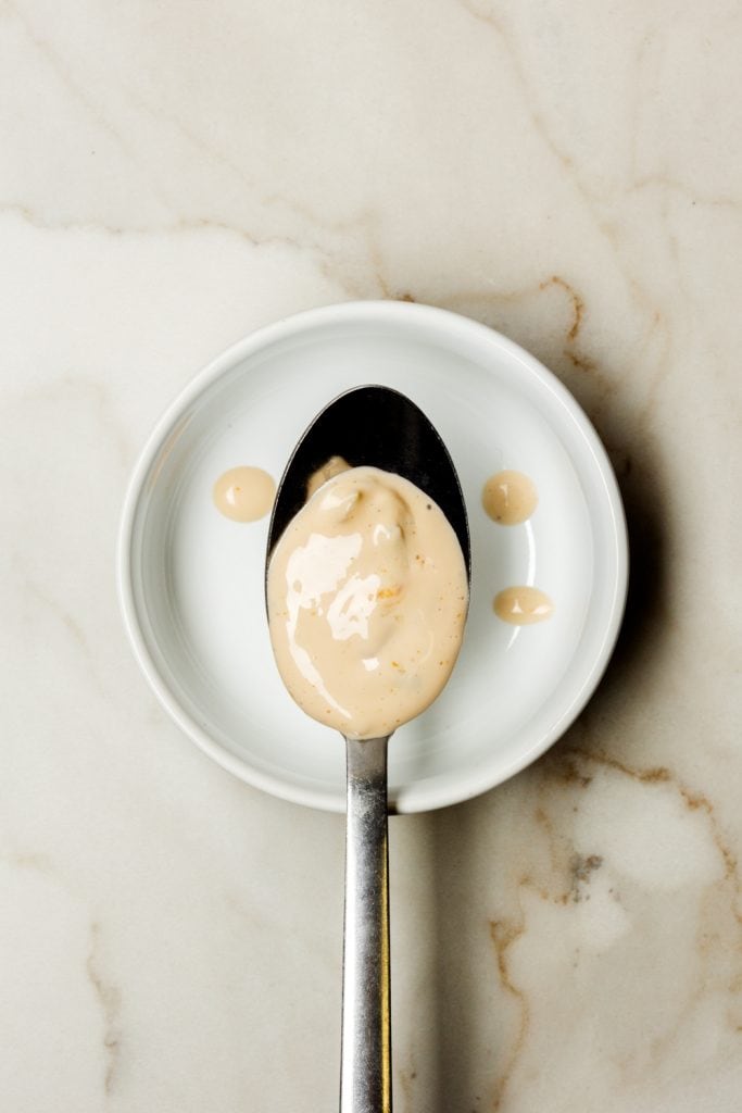 A white ramekin with a spoonful of thousand island dressing