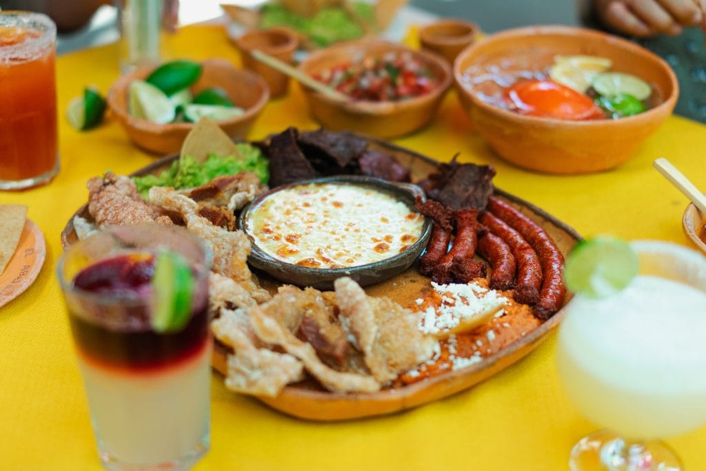 mexican food on a table with drinks