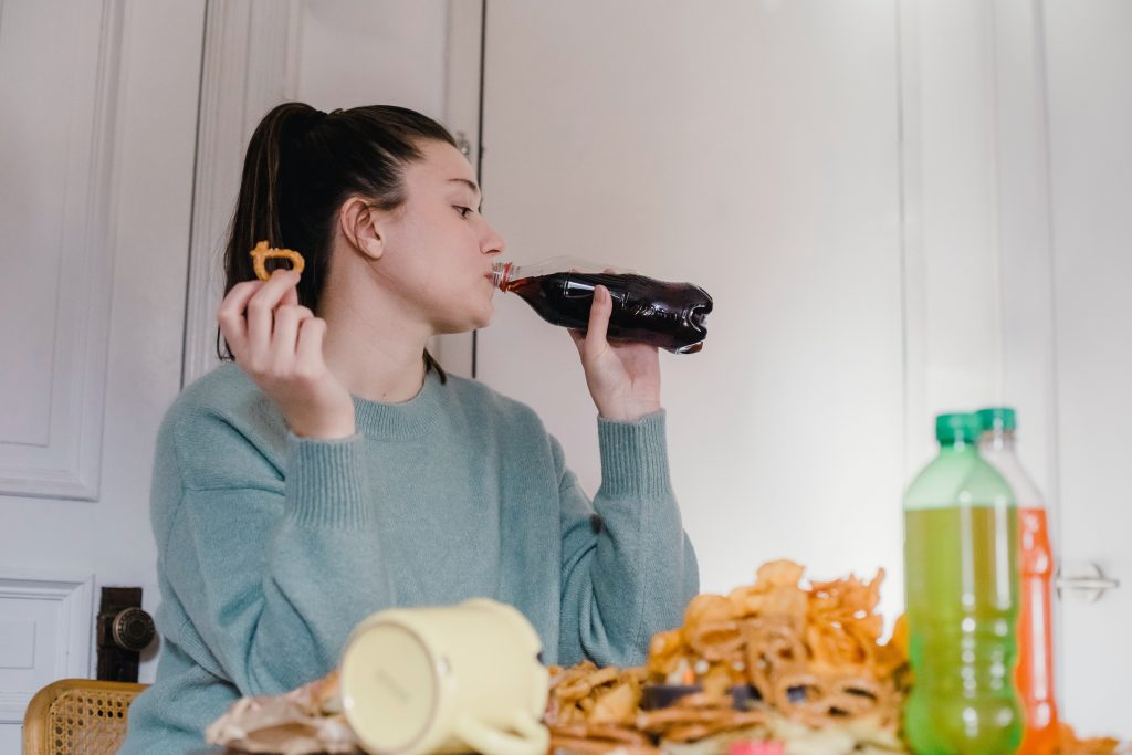 woman drinking soda on a keto cheat day