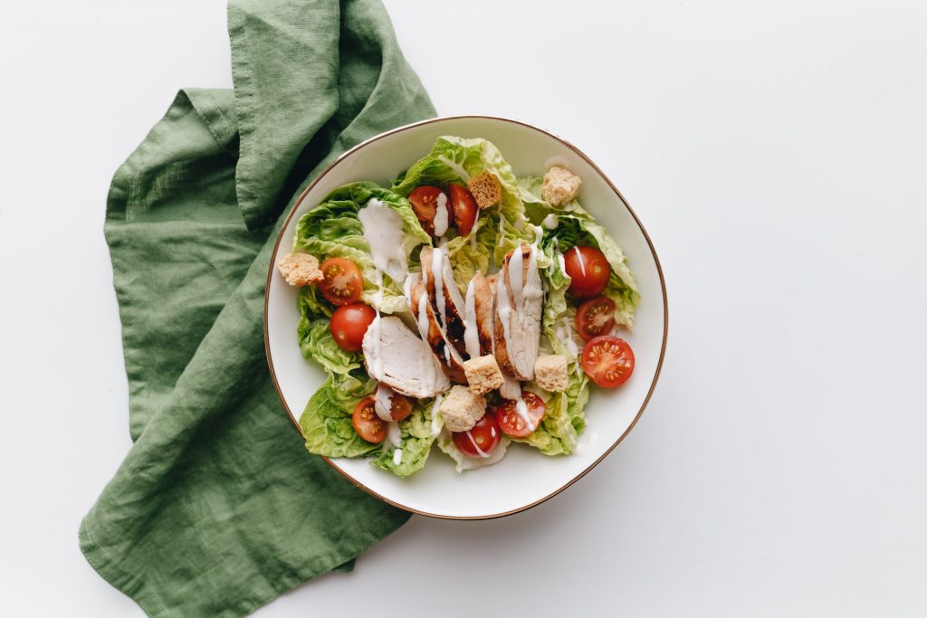 fresh salad with grilled chicken, cherry tomatoes, lettuce and dressing