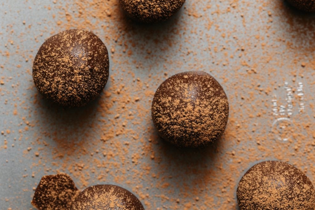 chocolate peanut butter balls on the baking sheet