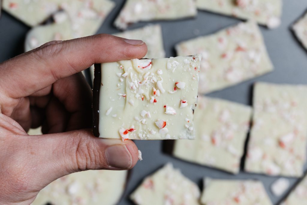 man's hand holding keto peppermint bark