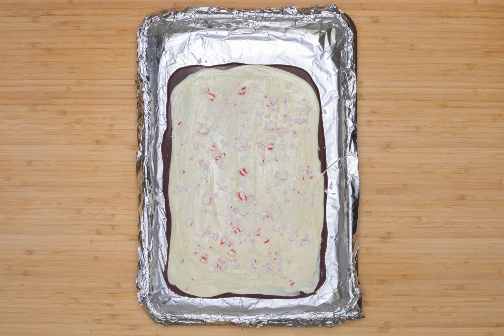 Keto Peppermint Bark layered chocolate on a baking sheet