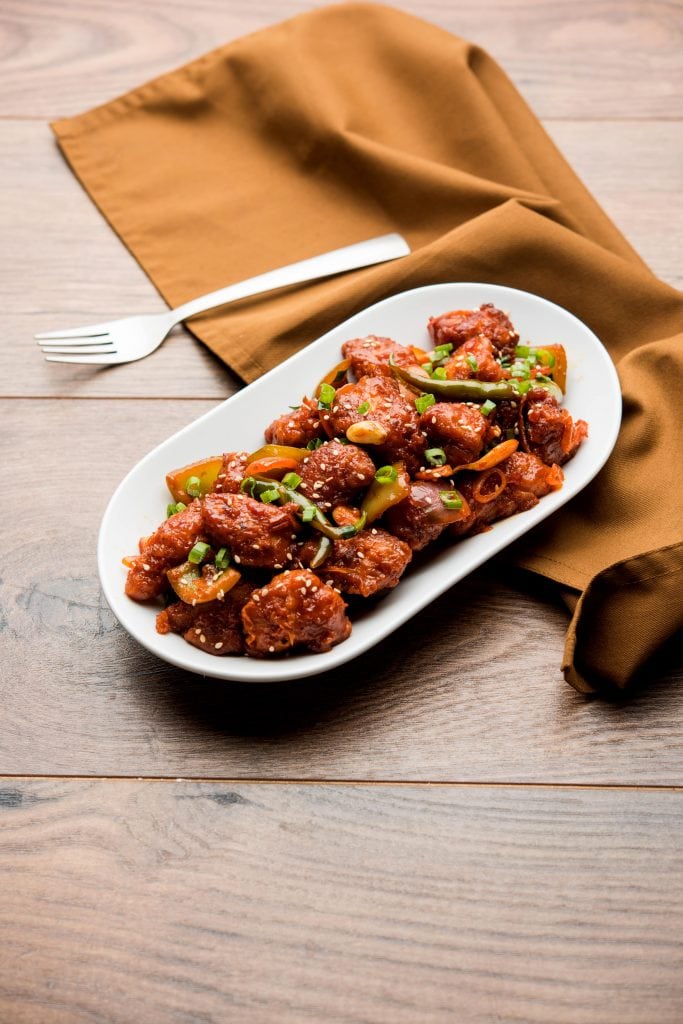 low carb orange chicken served on the wooden board