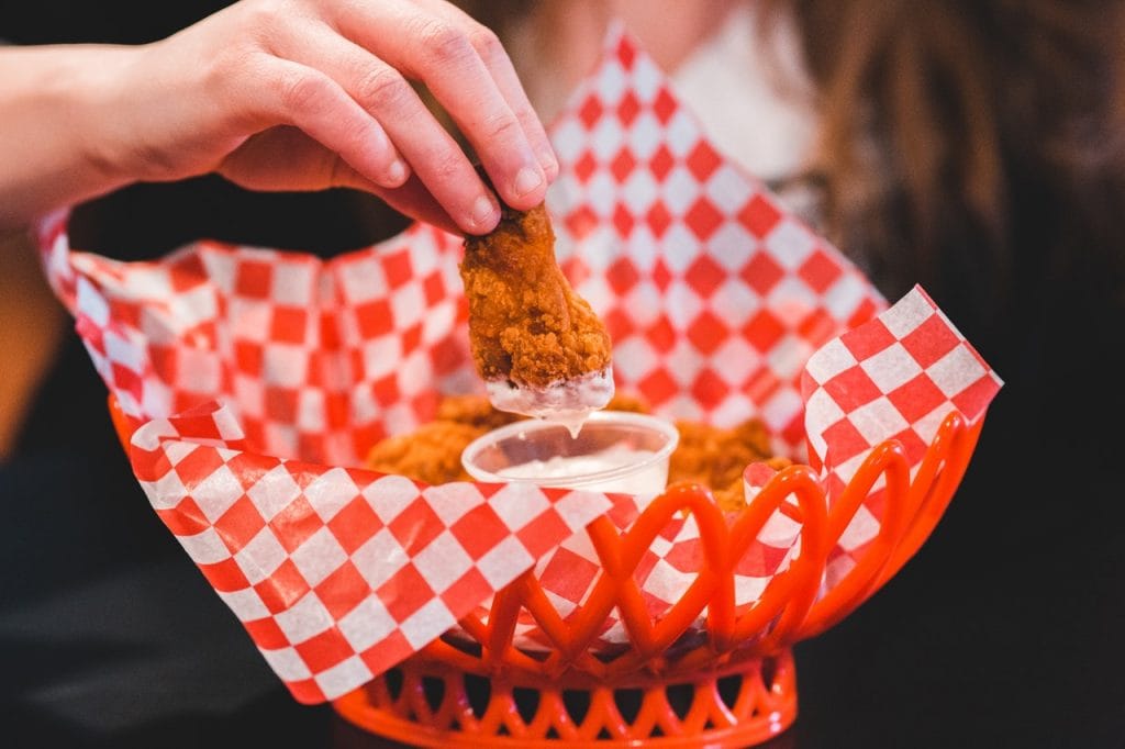 woman dipping food in the sauce