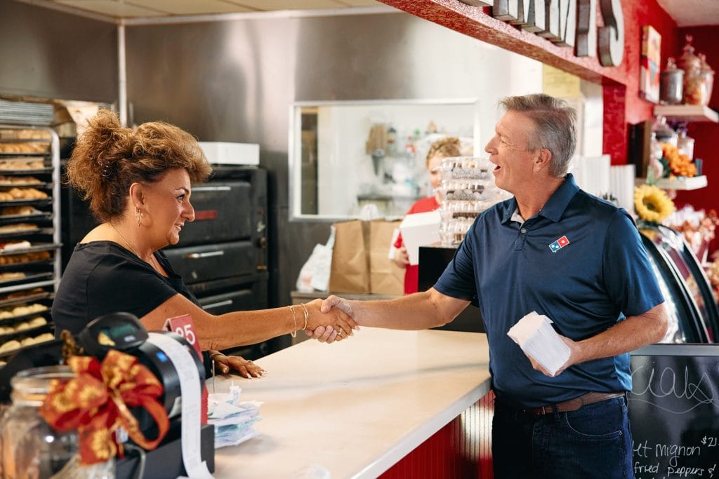 woman and man working at dominos