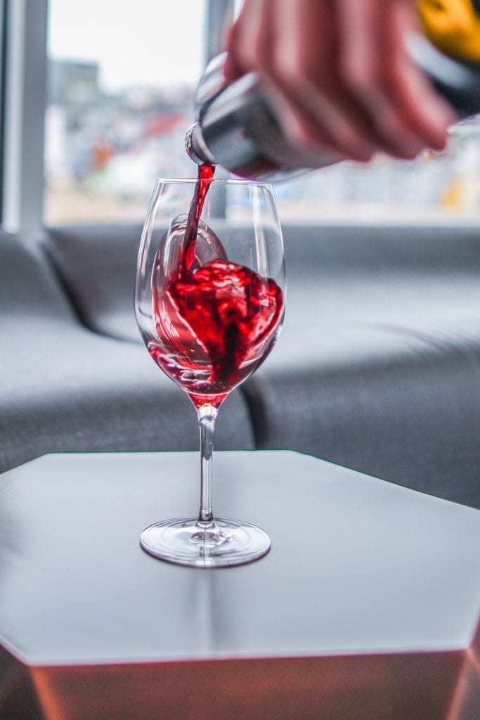 Dry Farm Wines Reviews pouring wine into a glass