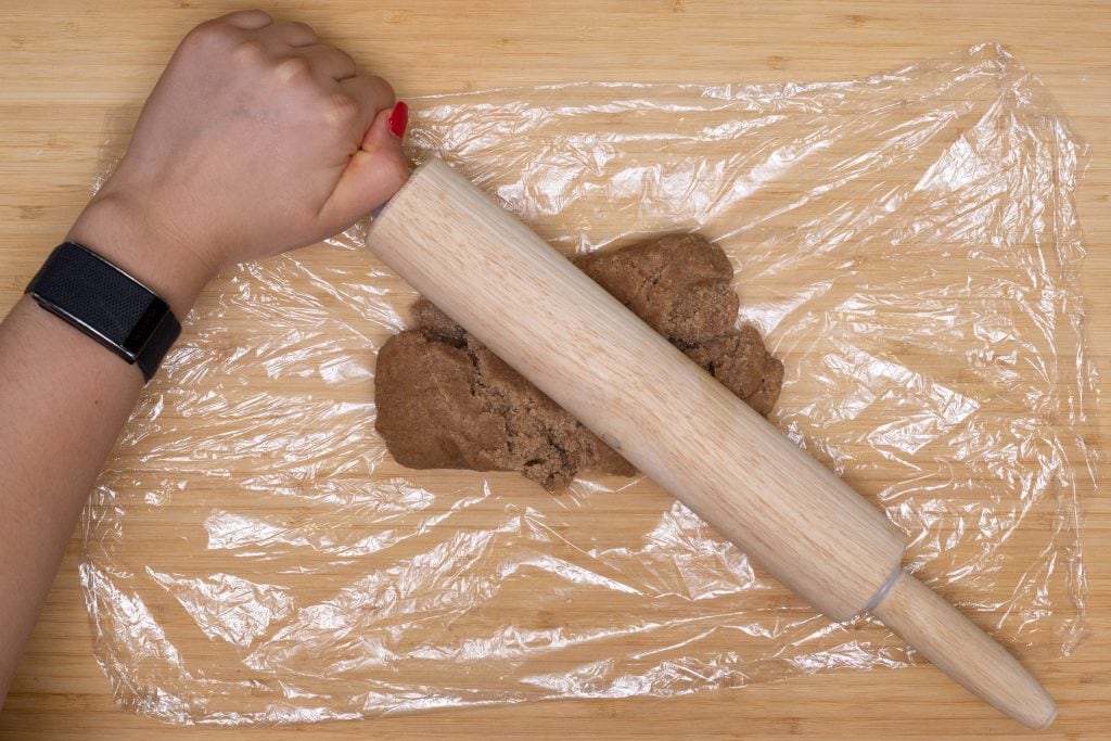 spreading the gingerbread dough on the plastic wrap