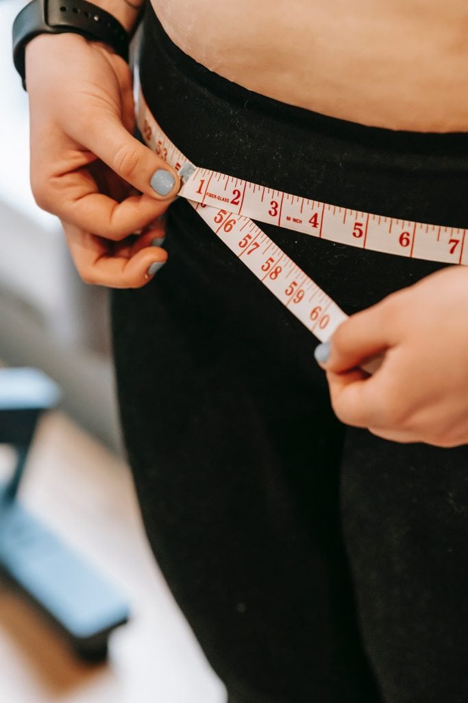 how long to lose 40 pounds on keto women measuring her hips with measuring tape