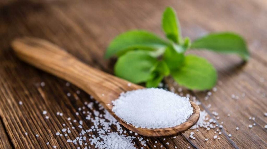 stevia powder with a wooden spoon