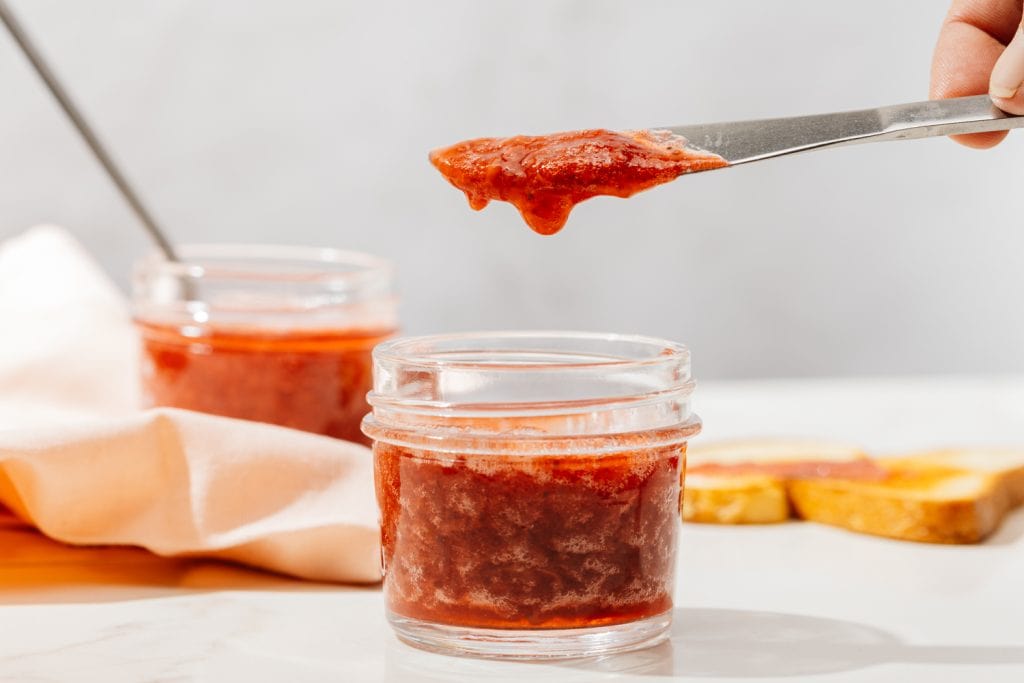 sugar free strawberry jam pouring from the knife