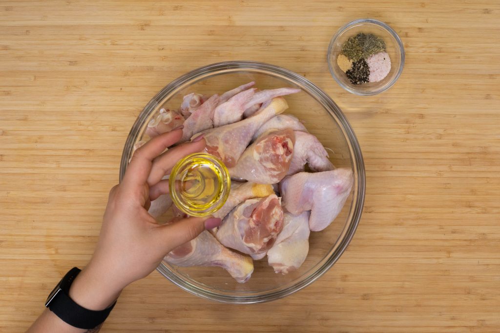 keto chicken wings Adding olive oil to chicken wings
