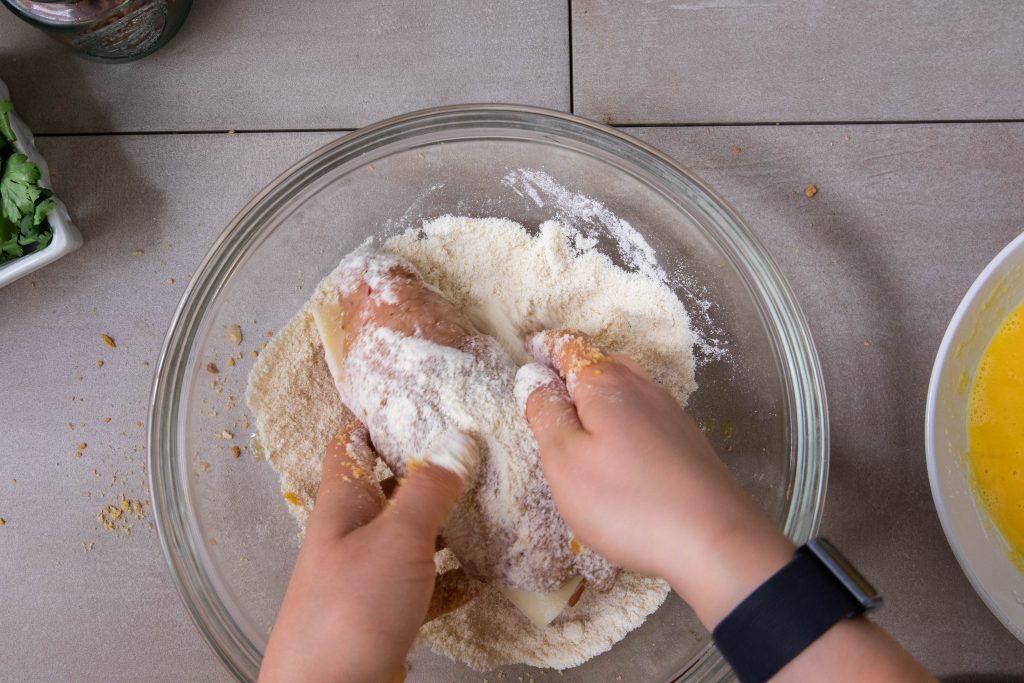 Coating chicken in flour