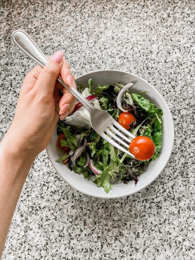 woman eating salad