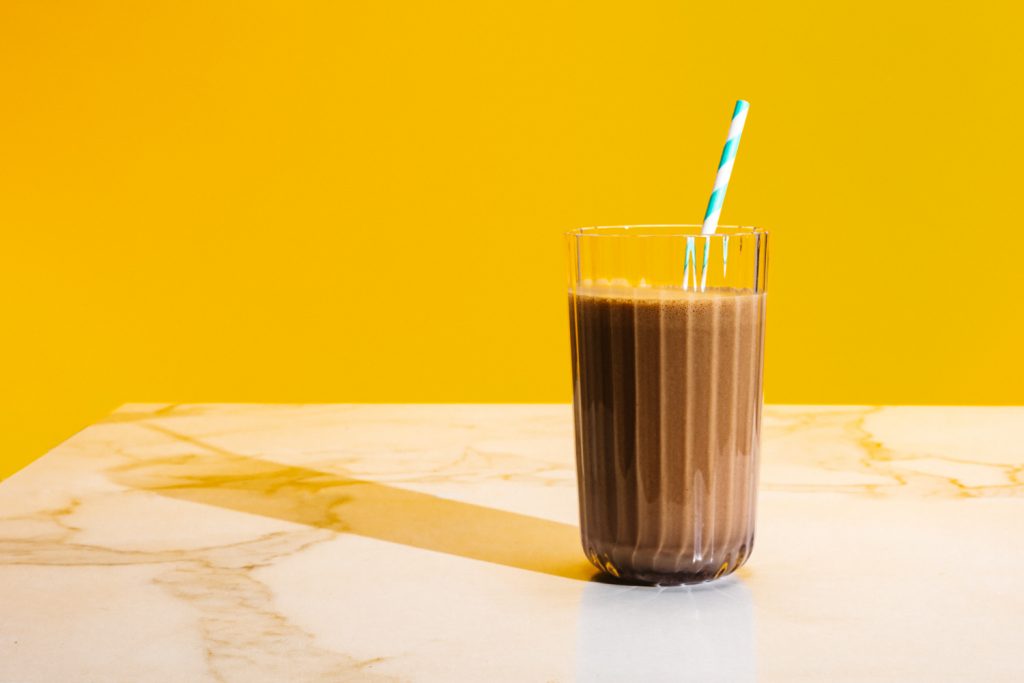 keto chocolate milk with a paper straw